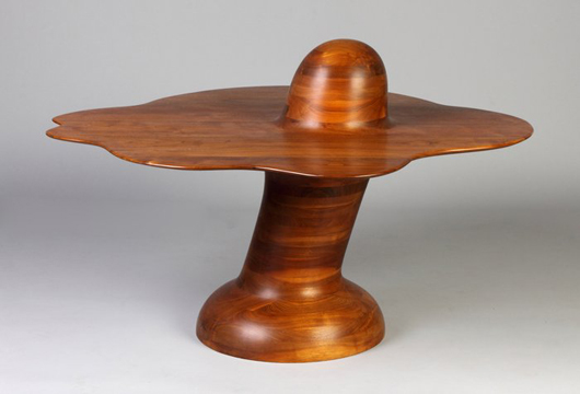 Stacked walnut mushroom table crafted in 1972 by Wendell Castle, artist initialed. Price realized: $48,300. Cottone Auctions image.